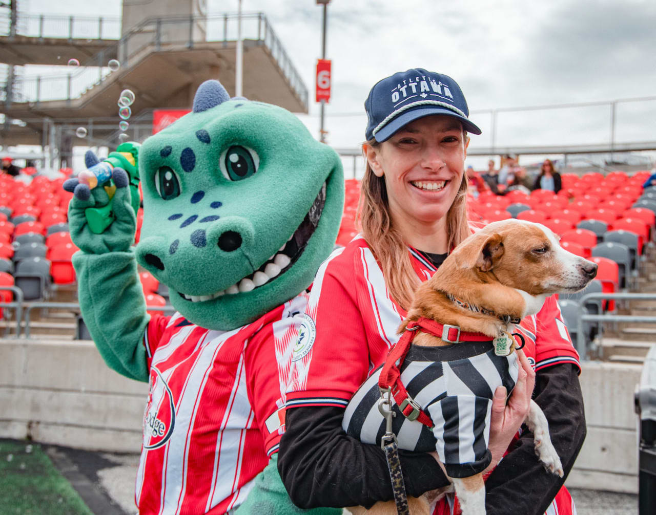 Woman holding a small dog at TD Place in Ottawa