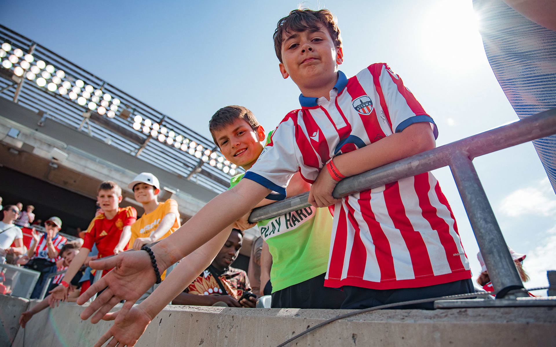 Young boys high-fiving players