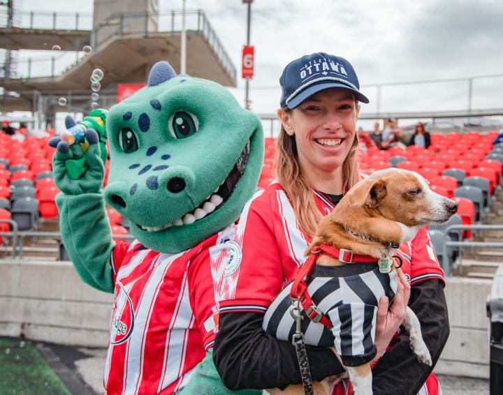 Woman holding a small dog at TD Place in Ottawa